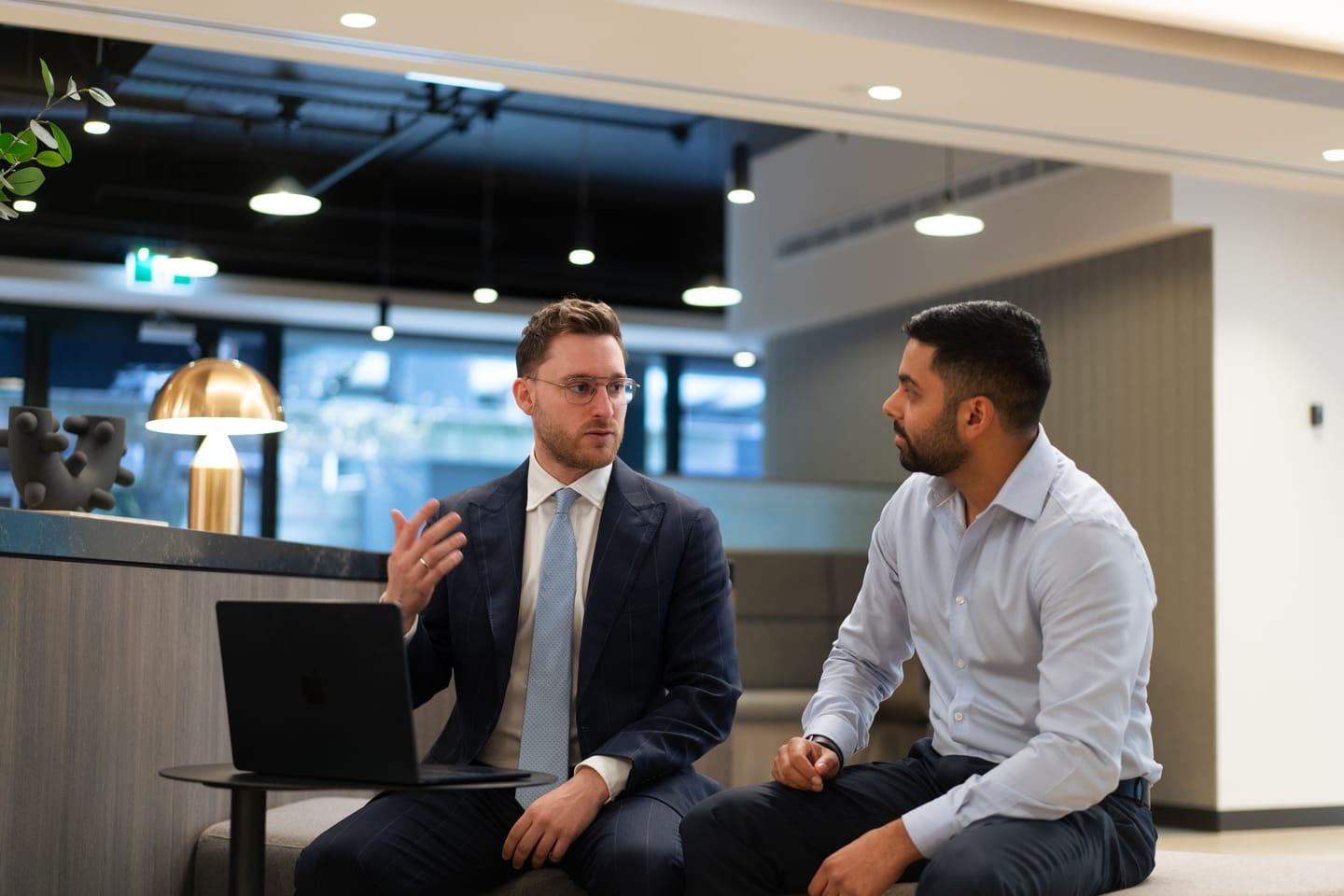 A broker and client in conversation during a sit-down consultation